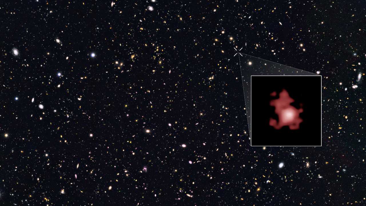 Galaxy GN-z11, shown in the inset, is seen as it was 13.4 billion years in the past, just 400 million years after the big bang, when the universe was only three percent of its current age. The galaxy is ablaze with bright, young, blue stars, but looks red in this image because its light has been stretched to longer spectral wavelengths by the expansion of the universe. Image credit: Wikipedia/NASA, ESA, P. Oesch (Yale University), G. Brammer (STScI), P. van Dokkum (Yale University), and G. Illingworth (University of California, Santa Cruz) 