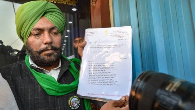 A farmers’ leader holds a copy of the govt proposal. PTI