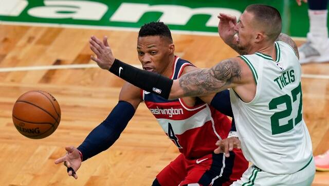 Washington Wizards guard Russell Westbrook (4) passes the ball under pressure from Boston Celtics center Daniel Theis (27) during the first quarter of an NBA basketball game. AP 