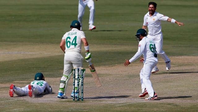 Pakistan’s Yasir Shah, and Abid Ali celebrate while teammate Mohammad Rizwan, left, takes the catch of South Africa’s Dean Elgar during the third day of the first Test match between Pakistan and South Africa. AP 