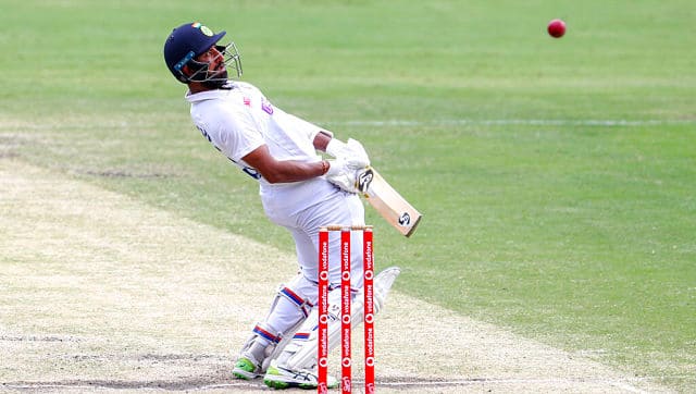 India’s Cheteshwar Pujara avoids a bouncer while batting during play on the final day of the fourth cricket test between India and Australia at the Gabba, Brisbane, Australia, Tuesday, Jan. 19, 2021. (AP Photo/Tertius Pickard)