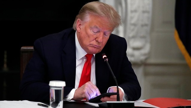 President Donald Trump looks at his phone during a roundtable with governors on the reopening of America's small businesses, in the State Dining Room of the White House in Washington. Though stripped of his Twitter account for inciting rebellion, President Donald Trump does have alternative options of much smaller reach. AP