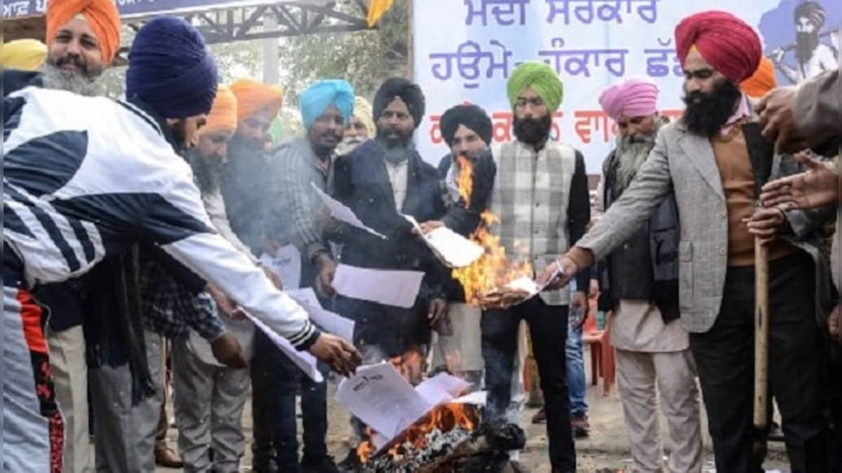 Protesting farmers burn copies of agri laws; day after meeting Shah, Dushyant Chautala meets Modi