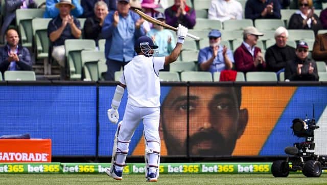 India’s Ajinkya Rahane acknowledges the applause as he walks back to the pavilion after his dismissal on the third day of the second cricket Test match between Australia and India at the MCG in Melbourne on December 28, 2020. (Photo by WILLIAM WEST / AFP) / –IMAGE RESTRICTED TO EDITORIAL USE - STRICTLY NO COMMERCIAL USE–