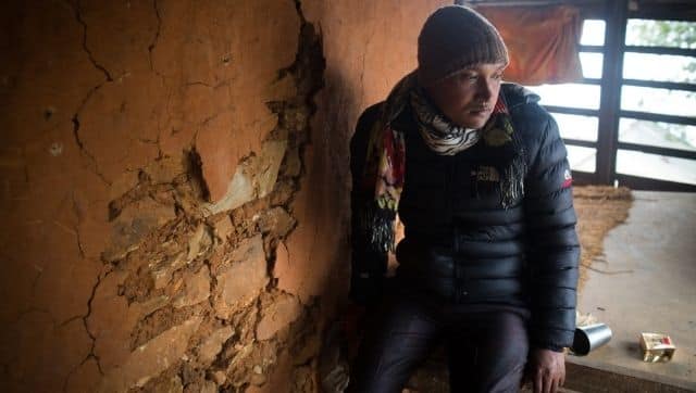 Krishna Majhi pictured at his house. The walls have cracks from the 2015 earthquake in Gumti, a village in Dhading. Photo by Nabin Baral/The Third Pole
