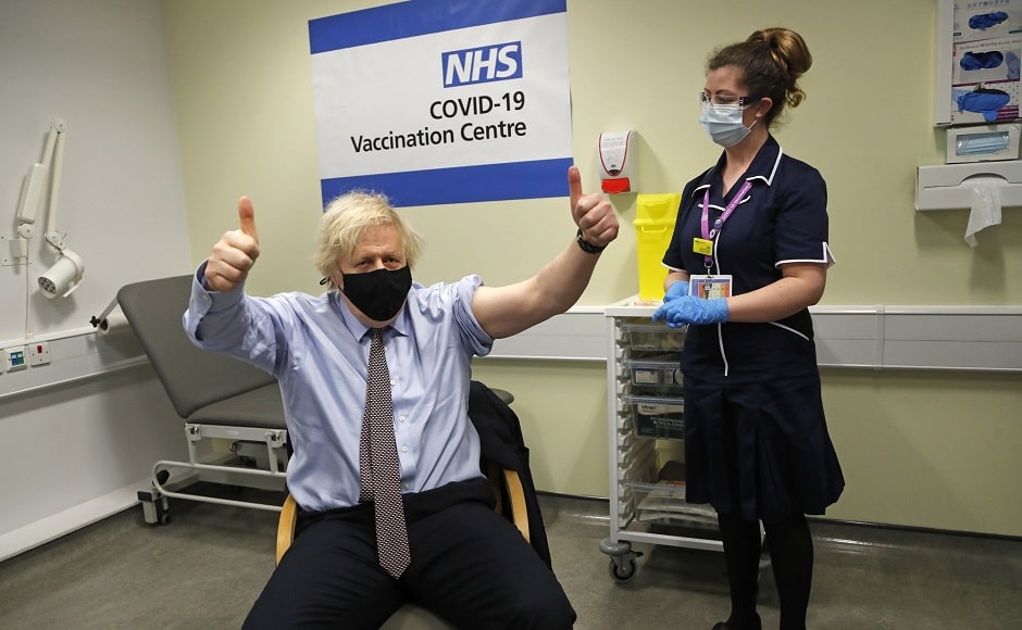 British prime minister Boris Johnson gestures after receiving the first dose of the AstraZeneca vaccine. Photo via AP/Frank Augstein