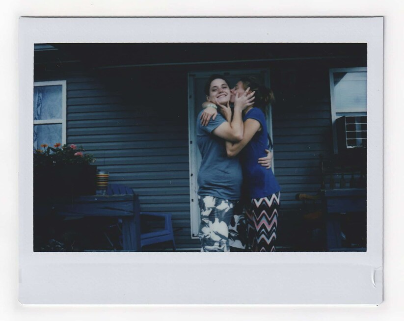 Tasha Lamm, 30, kisses her girlfriend Alicia Mullins, 22, in Bidwell, Ohio. Image via AP/Wong Maye-E