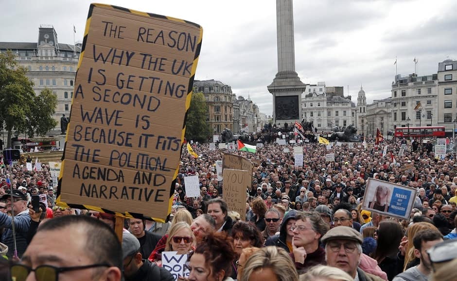 In this photo from Sept. 26, 2020, people take part in a "We Do Not Consent" rally at London's Trafalgar Square that was organized by Stop New Normal to protest against coronavirus restrictions. Image via AP/Frank Augstein