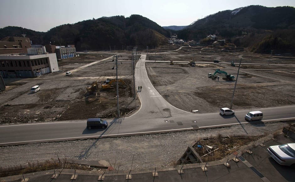 Two officials walk along a street in the tsunami and earthquake destroyed town of Onagawa, Miyagi Prefecture, northern Japan on 22 February, 2012. Image via The Associated Press/David Guttenfelder Two officials walk along a street in the tsunami and earthquake destroyed town of Onagawa, Miyagi Prefecture, northern Japan on 22 February, 2012. Image via The Associated Press/David Guttenfelder