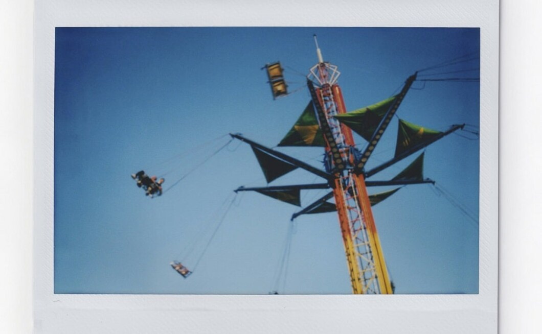 Photographer Maye-E Wong was part of a team that drove the backroads during the run-up to the 2020 election. She illustrated stories about currents of racial tension that still ripple through towns that once expelled Black people, about how claims of a gentler political culture in Utah turned out to be far more complicated than the folklore. Above, people spin around in an amusement ride at the annual Mississippi State Fair. Image via AP/Wong Maye-E