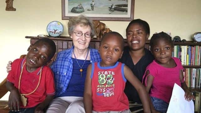 Sister Janice McLaughlin with children in Zimbabwe. Image via The Associated Press/ Maryknoll Sisters