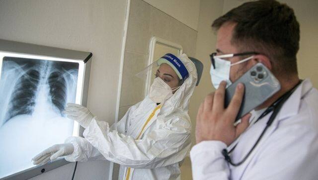 Jashari, left, assists pulmonologist Flamur Marku at the Pulmonological Clinic in Kosovo's capital Pristina on Monday, 8 March, 2021. Photo via The Associated Press/Visar Kryeziu