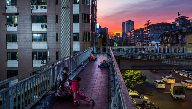 File image of people gathering on a pedestrian walkway in Yangon. © 2021 The New York Times