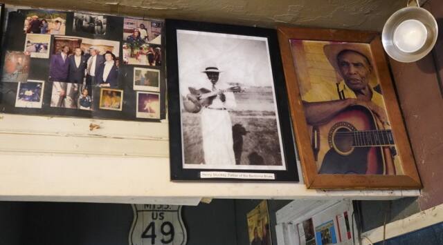 Portraits of Henry Stuckey, the originator of the Bentonia blues, second from right, and area resident and bluesman Jack Owens, hang high on the wall at the Blue Front Café. (AP Photo/Rogelio V Solis)