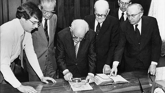Hofmann (far left) with LDS Church leaders. Still from Murder Among the Mormons