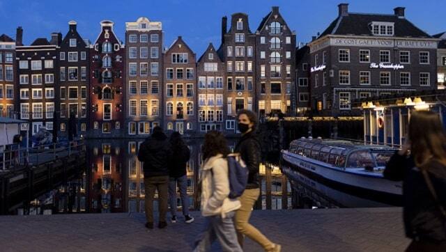 Empty canal boats in the center of Amsterdam in March 2021. (Ilvy Njiokiktjien/The New York Times)