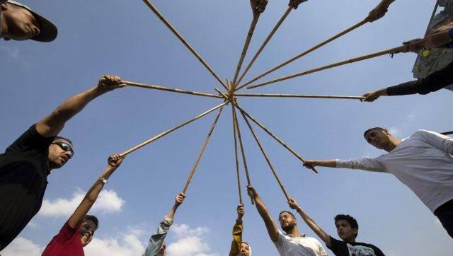 Youths take part in a training session of Egypt's combative sport of 'tahtib' (stick-fighting), at a sporting club in the Rihab suburb on the eastern outskirts of the capital Cairo. AFP.