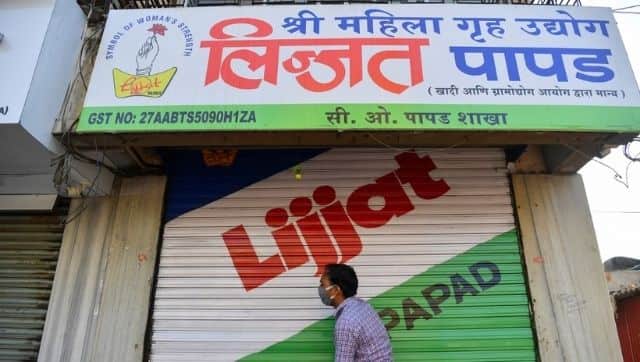 In this photograph taken on March 8, 2021, a staff member of Shri Mahila Griha Udyog, the organisation that produces the famous Lijjat Papad, opens one of the organisation's facilities in Mumbai. Indranil Mukherjee / AFP