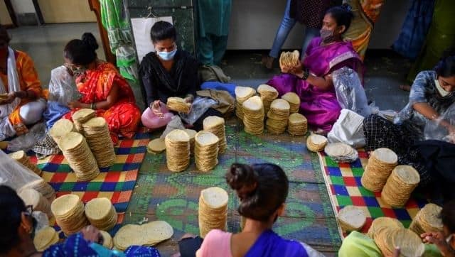 In this photograph, members of Shri Mahila Griha Udyog, the organisation that produces the famous Lijjat Papad, arrange rolled papads for delivery at one of the organisation's facilities in Mumbai. Indranil Mukherjee / AFP
