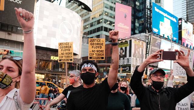 People gather in Times Square following the verdict in the murder trial of Derek Chauvin, a former Minneapolis police officer. By Simbarashe Cha © 2021 The New York Times