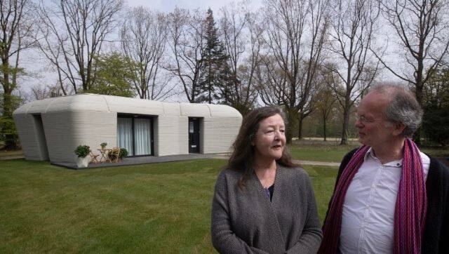 Tenants Elize Lutz, left, and Harrie Dekkers' new home is a 1,011-square feet two-bedroom bungalow resembling a boulder with windows in Eindhoven, Netherlands. AP photo