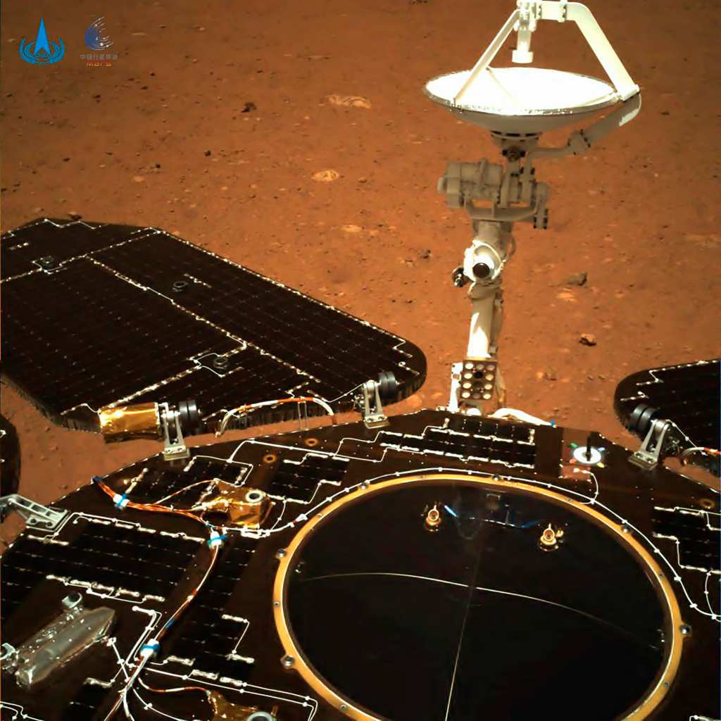 The second image which is a colour photo was taken by the navigation camera that is on the rear of the rover. One can see the solar panels and antenna unfolding along with the red soil and rocks on the Martian surface. Image credit: CNSA via AP 