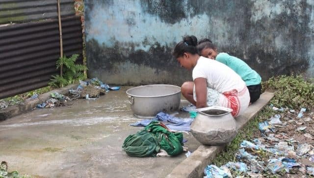 Girls wash clothes on a platform close to the pond (Image: Sanskrita Bharadwaj)