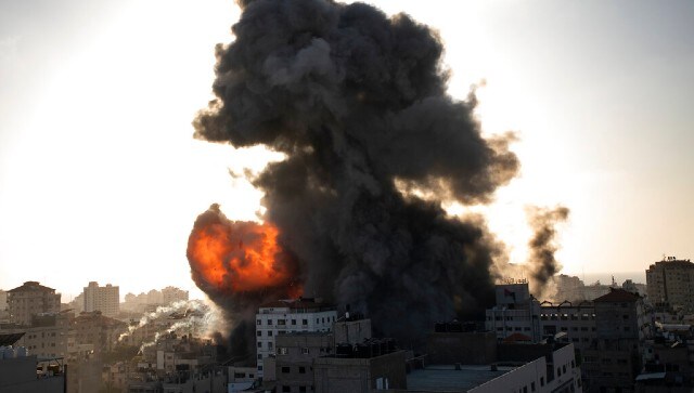 Smoke and fire rises following Israeli airstrikes on a building in Gaza City on 12 May. AP
