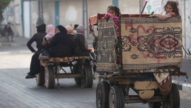 Palestinians flee their homes after overnight Israeli heavy missile strikes on their neighborhoods in the outskirts of Gaza City. AP