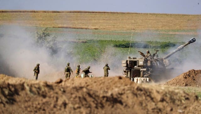 An Israeli artillery unit fires toward targets in Gaza Strip, at the Israeli Gaza border. AP