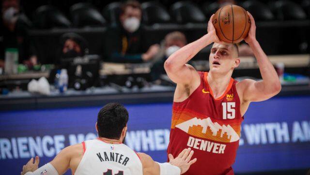 Denver Nuggets center Nikola Jokic (15) shoots over Portland Trail Blazers center Enes Kanter (11) in the first quarter of Game 2 of a first-round NBA basketball playoff series Monday, May 24, 2021, in Denver. (AP Photo/Joe Mahoney)