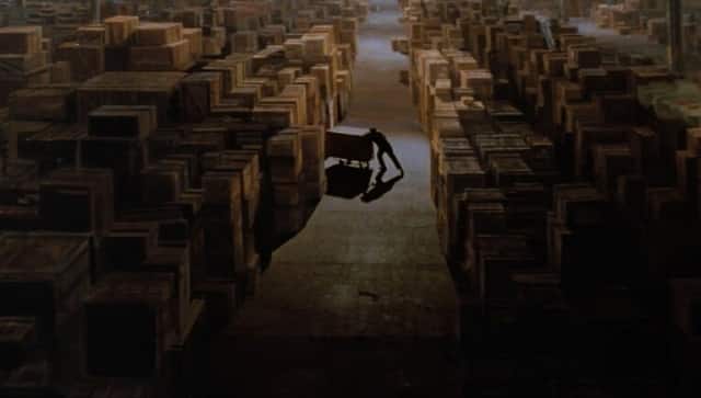 A scene from the end of Raiders of the Lost Ark. Much of the warehouse is a matte painting made by Michael Pangrazio | Credit: Paramount Pictures