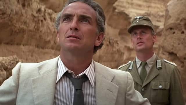 Paul Freeman, foreground, and the fly on his lower lip | Credit: Paramount Pictures