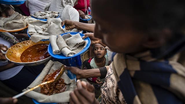Among displaced Tigrayans lining up to receive food donated by local residents, a young boy. AP Photo/Ben Curtis