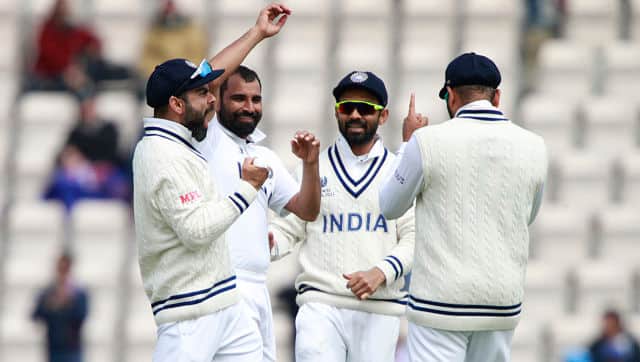 India’s captain Virat Kohli, left, and Mohammed Shami, second left, celebrate with teammates the dismissal of New Zealand’s Colin de Grandhomme. AP