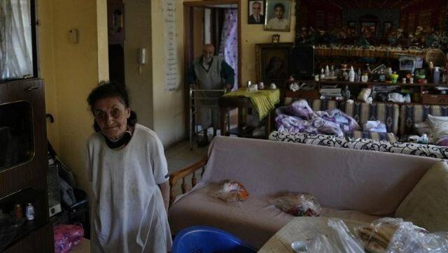 The elderly couple Marie Orfali and her husband Raymond from Lebanon have to resort to soup kitchens and charities to fetch food in these times of crisis, in the absence of a national healthcare system. Image via The Associated Press/ Hassan Ammar