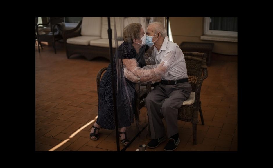 AP’s chief photographer in Spain, Emilio Morenatti, won the feature photography prize. Work by 10 AP photographers won the breaking news prize. | In the picture: Agustina Cañamero, 81, hugs and kisses her husband Pascual Pérez, 84, through a plastic film screen to avoid contracting the coronavirus at a nursing home in Barcelona, Spain, on 22 June, 2020. Even when it comes wrapped in plastic, a hug can convey tenderness and relief, love and devotion. The fear that gripped Agustina Cañamero during the 102 days she and her 84-year-old husband spent physically separated during Spain's coronavirus outbreak dissolved the moment the couple embraced through a screen of plastic film. The image was part of a series by Associated Press photographer Emilio Morenatti that won the 2021 Pulitzer Prize for feature photography. Photo via The Associated Press/Emilio Morenatti AP’s chief photographer in Spain, Emilio Morenatti, won the feature photography prize. Work by 10 AP photographers won the breaking news prize. | In the picture: Agustina Cañamero, 81, hugs and kisses her husband Pascual Pérez, 84, through a plastic film screen to avoid contracting the coronavirus at a nursing home in Barcelona, Spain, on 22 June, 2020. Even when it comes wrapped in plastic, a hug can convey tenderness and relief, love and devotion. The fear that gripped Agustina Cañamero during the 102 days she and her 84-year-old husband spent physically separated during Spain's coronavirus outbreak dissolved the moment the couple embraced through a screen of plastic film. The image was part of a series by Associated Press photographer Emilio Morenatti that won the 2021 Pulitzer Prize for feature photography. Photo via The Associated Press/Emilio Morenatti
