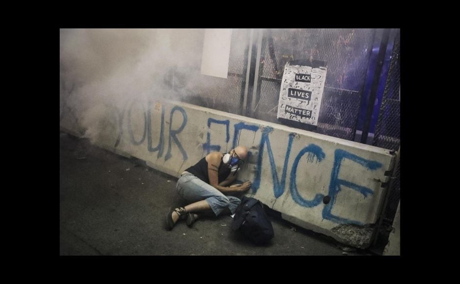 The AP also had two Pulitzer finalists in the investigative reporting category and an additional finalist for breaking news photography. This is the second year in a row AP has won the Pulitzer for feature photography. AP last won both photography prizes in 1999. | In the picture: A demonstrator hides under a barrier as federal officers release tear gas during a Black Lives Matter protest at the Mark O Hatfield United States Courthouse, 29 July, 2020, in Portland, Ore. The image was part of a series of photographs by The Associated Press that won the 2021 Pulitzer Prize for breaking news photography. Photo via The Associated Press/Marcio Jose Sanchez The AP also had two Pulitzer finalists in the investigative reporting category and an additional finalist for breaking news photography. This is the second year in a row AP has won the Pulitzer for feature photography. AP last won both photography prizes in 1999. | In the picture: A demonstrator hides under a barrier as federal officers release tear gas during a Black Lives Matter protest at the Mark O Hatfield United States Courthouse, 29 July, 2020, in Portland, Ore. The image was part of a series of photographs by The Associated Press that won the 2021 Pulitzer Prize for breaking news photography. Photo via The Associated Press/Marcio Jose Sanchez