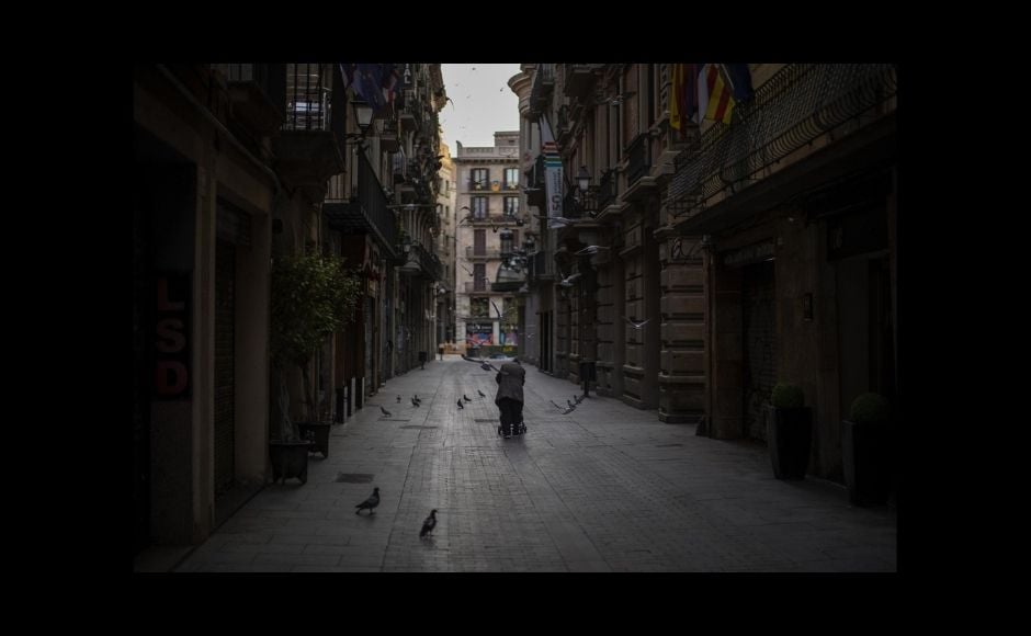 Associated Press photographers awarded the Pulitzer Prize on Friday had dodged tear gas to capture protests against racial injustice and patiently built trust with elderly people to empathetically document the toll of the coronavirus pandemic. | In the picture: A woman pushes a cart with her belongings as she walks along an empty street in downtown Barcelona, Spain, on 21 March, 2020. The image was part of a series by Associated Press photographer Emilio Morenatti that won the 2021 Pulitzer Prize for feature photography. Photo via The Associated Press/Emilio Morenatti Associated Press photographers awarded the Pulitzer Prize on Friday had dodged tear gas to capture protests against racial injustice and patiently built trust with elderly people to empathetically document the toll of the coronavirus pandemic. | In the picture: A woman pushes a cart with her belongings as she walks along an empty street in downtown Barcelona, Spain, on 21 March, 2020. The image was part of a series by Associated Press photographer Emilio Morenatti that won the 2021 Pulitzer Prize for feature photography. Photo via The Associated Press/Emilio Morenatti