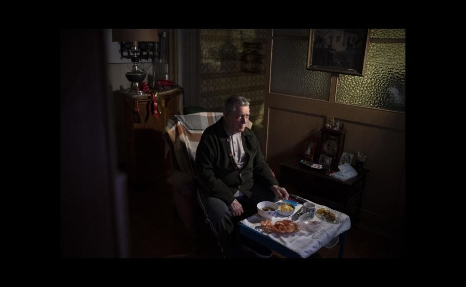 Morenatti separated himself from his family for months to avoid the risk of exposure as he documented the toll of COVID-19 on the elderly. He credited half the award to his wife, who took care of their children, and the other half to his colleagues. | In the picture: Álvaro Puig Moreno watches television while eating a his Christmas Eve dinner at his home in Barcelona, Spain, on 24 December, 2020. "The solitude gets to me these days, I often feel depressed," Puig said. "These holidays, instead of making me happy, make me sad. I hate them. Most of family has died, I am one of the last ones left. I will spend Christmas at home alone because I don't have anyone to spend them with." The image was part of a series by Associated Press photographer Emilio Morenatti that won the 2021 Pulitzer Prize for feature photography. Photo via The Associated Press/Emilio Morenatti Morenatti separated himself from his family for months to avoid the risk of exposure as he documented the toll of COVID-19 on the elderly. He credited half the award to his wife, who took care of their children, and the other half to his colleagues. | In the picture: Álvaro Puig Moreno watches television while eating a his Christmas Eve dinner at his home in Barcelona, Spain, on 24 December, 2020. "The solitude gets to me these days, I often feel depressed," Puig said. "These holidays, instead of making me happy, make me sad. I hate them. Most of family has died, I am one of the last ones left. I will spend Christmas at home alone because I don't have anyone to spend them with." The image was part of a series by Associated Press photographer Emilio Morenatti that won the 2021 Pulitzer Prize for feature photography. Photo via The Associated Press/Emilio Morenatti
