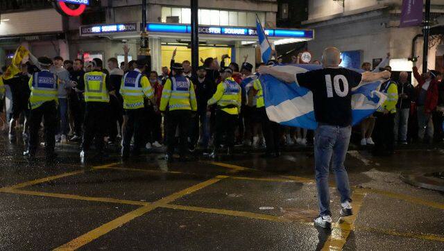 A Scotland supporter celebrates outside Leicester Square tube station in London after the Euro 2020 match between England and Scotland. AP