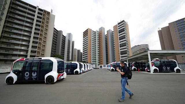 Autonomous electric vehicles which will be used around the main facilities. AP Photo