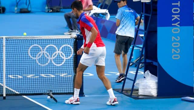 Novak Djokovic smashes his racquet in frustration during the Tokyo 2020 tennis men's semi-final against Spain's Pablo Carreno Busta. AP