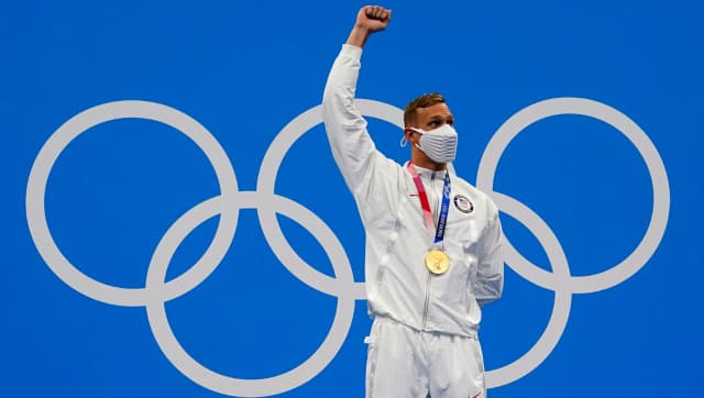 American swimmer Caleb Dressel celebrates after winning gold in the men's 100m butterfly event. AP