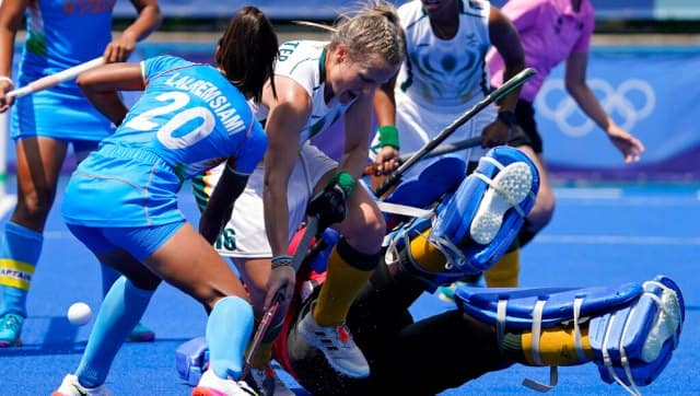 South Africa's Erin Hunter vies for the ball with India's Lalremsiami in the women's hockey Pool A clash, which the Indians won 4-3. AP