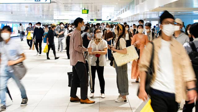 People wearing face masks chat before parting at a train station in Tokyo, Friday, 9 July, 2021. A state of emergency began Monday, 12, 2021 July, in Tokyo, as the number of new cases is climbing fast and hospital beds are starting to fill just 11 days ahead of the Tokyo Olympics. AP