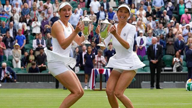 Belgium’s Elise Mertens, left, and Taiwan’s Su-Wei Hsieh pose for the media with their winners trophies. AP