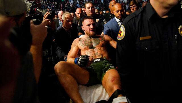 Conor McGregor is carried off on a stretcher after losing to Dustin Poirier. AP