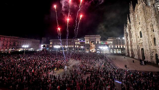 Fans celebrate in Piazza Duomo in Milan, Italy Sunday, 11 July, 2021 after their team won the European Championship against England. AP