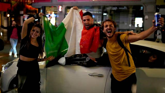 Italian fans celebrate in central London, in the early hours of Monday, 12 July, 2021, after Italy won the Euro 2020 soccer championship final match between England and Italy played at Wembley Stadium. Italy beat England 3-2 in a penalty shootout after a 1-1 draw. AP